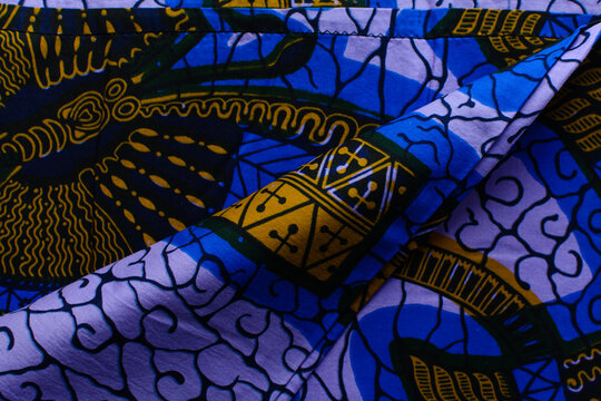 top view of purple blue ankara fabric, flatlay of nigerian wax cloth with designs, spread out purple blue ankara material
