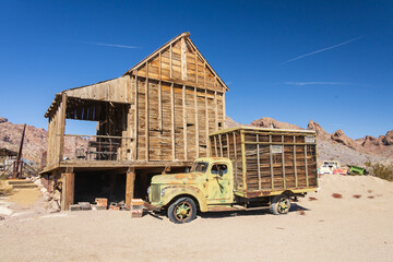 Abandoned vintage rusted vehicle in a desert junkyard

