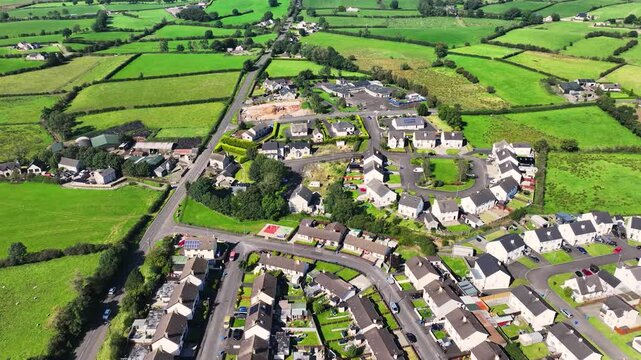 Aerial view of Residential homes, town houses, bungalows, housing, in Loughguile village Co Antrim Northern Ireland 