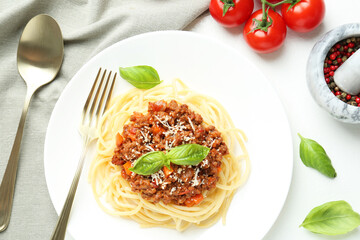 Tasty pasta bolognese served on white table, flat lay