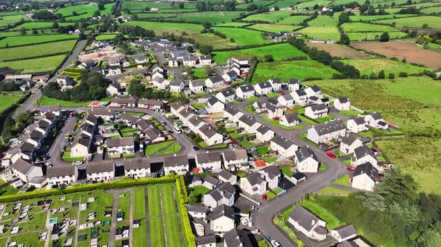 Aerial view of Residential homes, town houses, bungalows, housing, in Loughguile village Co Antrim Northern Ireland 