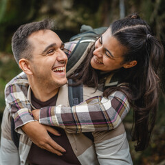 Fototapeta premium Portrait of hugged hiker couple backpackers around forest