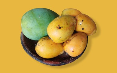 bunch of mangoes on traditional earthen tray isolated