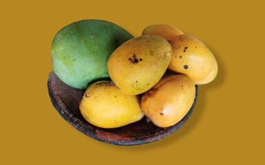 bunch of mangoes on traditional earthen tray isolated