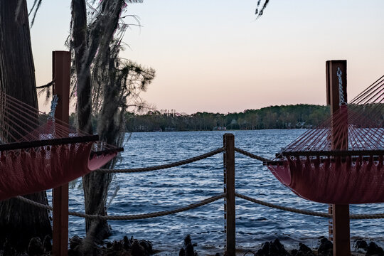 Sunset views over Byron Lake create a mesmerizing scene, with the golden light reflecting off the calm waters. The silhouette of trees and the soft colors in the sky bring out the peaceful, serene bea