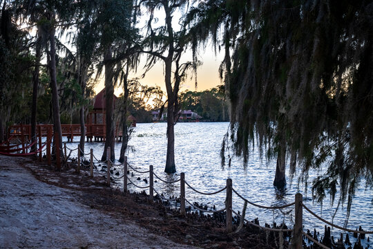 Sunset views over Byron Lake create a mesmerizing scene, with the golden light reflecting off the calm waters. The silhouette of trees and the soft colors in the sky bring out the peaceful, serene bea