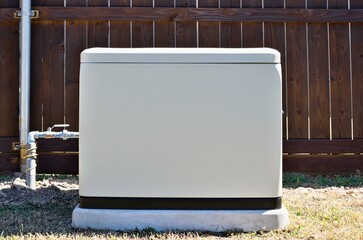Standby home generator set in residential backyard emergency backup power supply.	