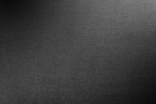 Classic rough dark black tone color paint on environmental eco friendly cardboard box paper texture background with space minimal style