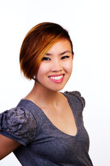 Portrait Of Young Asian American Woman Against White Background