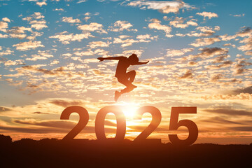 Silhouette of man jumping to Happy new year 2025 in sunset or sunrise background.