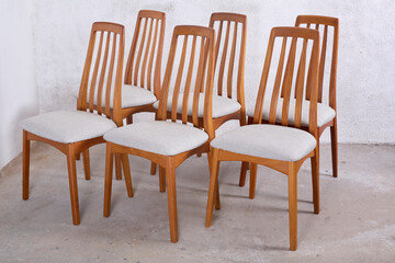 1960s-style wooden dining chair. Mint green upholstered seat with teak frame. Mid-century modern furniture. 