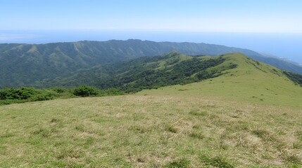 Fototapeta premium Lush Green Mountain Ridge with Ocean View