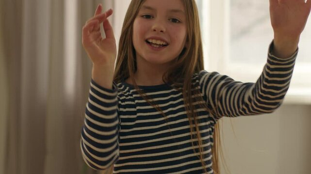 Caucasian European little girl child dancing moving music rhythm schoolgirl preteen age daughter fun childish laughter smile joy weekend vacation holiday plasticity offspring baby happy young female