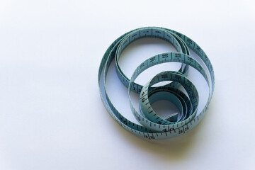 Blue measuring tape with various layouts isolated on white background.