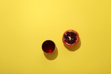 Fresh juicy pomegranate on a yellow background