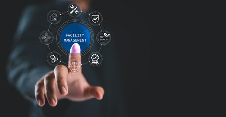 Facility management concept. Businessman with facility management icon on virtual screen, building resource management covers activities related to buildings or various locations.