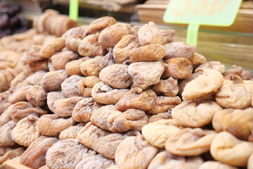 A vibrant display of dried figs and various fruits beautifully piled at the market stall