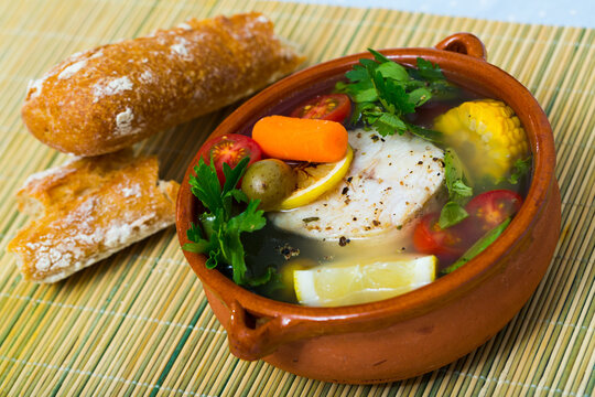 Recipe of pottage of fisherman: boil merluccius head for broth. Add potatoes, carrots, shallots, corn, fish steak 200 g, salt, pepper. Bring to oven, cook for 40min at temperature of 200 deg