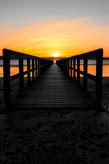 Fototapeta premium Pier at sunset, tranquil water view