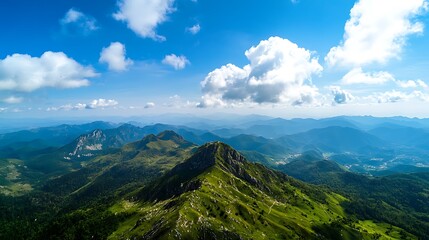 Naklejka premium Aerial View of Lush Green Mountains and Clouds