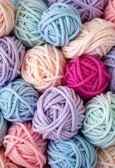 A Cozy Collection of Soft Yarn Balls in Pastel Shades: Light Blue, Pink, Lavender, and Bold Fuchsia for Craft Lovers