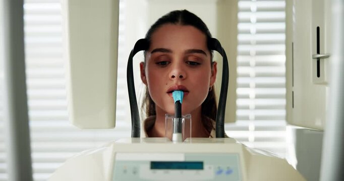 Dental, radiation and patient with xray machine at dentist for digital panoramic image, oral hygiene and gum disease. Girl, mouth radiography and person with surgery examination at stomatology clinic
