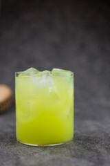 Fresh green guava juice with ice cube in mini glass. Refreshing drink