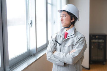 不安そうに上を見る作業員