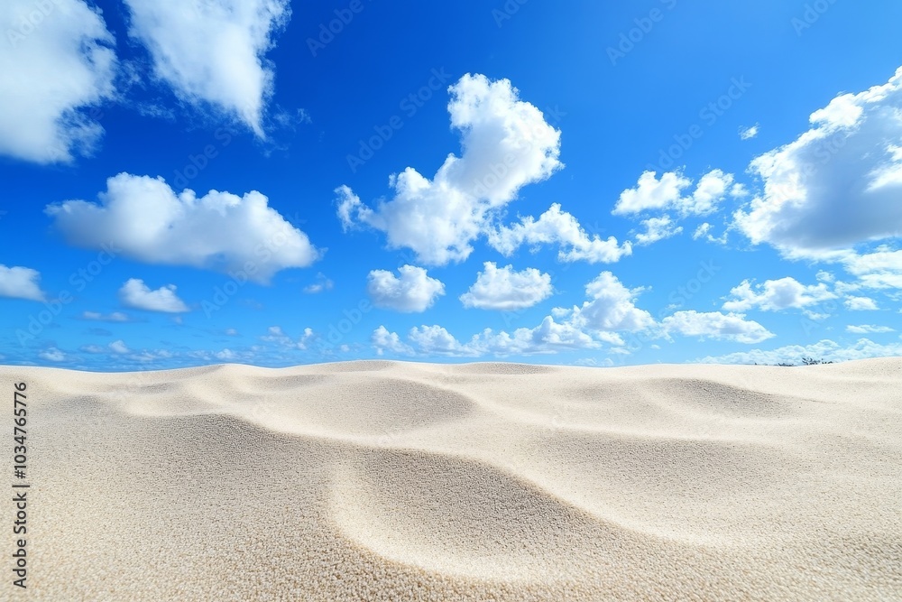Wall mural a vast expanse of white sand dunes under a clear blue sky with fluffy white clouds.