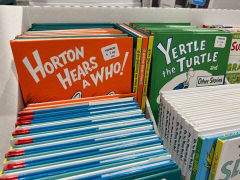 Books by Dr. Seuss on display stand inside Costco warehouse.