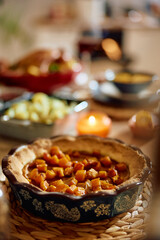 Thanksgiving pumpkin pie on dining table.