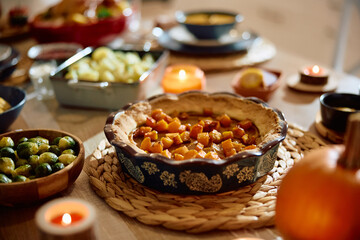 Holiday pumpkin pie on dining table.