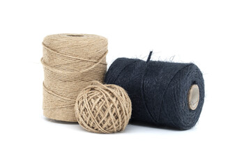 Assorted jute and twine spools on white background showcasing natural fiber materials