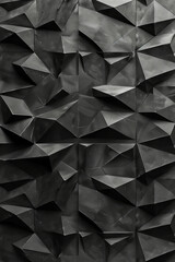 Fototapeta premium A striking wall featuring a unique geometric pattern of angular black facets creates a contemporary atmosphere. The texture adds depth and interest, making it an eye-catching design element.