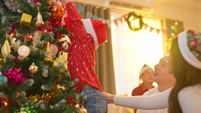 celebrate christmas party asian family multi generation decorating christmas tree with ball light present gift box happiness casual cheerful family enjoy house setting for thanksgiving night together