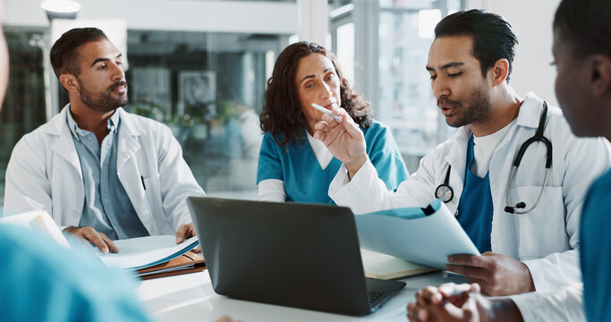 Doctor, nurse and laptop with discussion in clinic for healthcare treatment innovation or IRB approval report. Diversity, team or medical staff in hospital boardroom with paperwork for patient record
