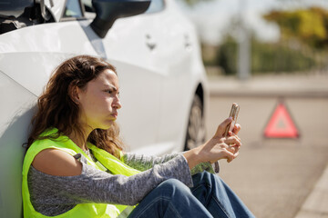 Stressed young woman stranded in the middle of the road because her car broke down. She calls for...