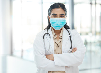 Portrait, woman and doctor with face mask in hospital of healthcare services, ppe safety and medical compliance. Girl, surgeon and arms crossed for virus danger, wellness risk and about us of surgery