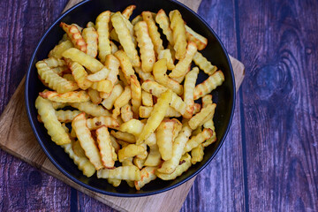  Home made   Fresh fried French fries  in a bowl on wooden rustic  background
