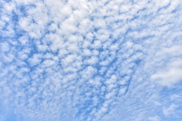  Image of a blue sky and some clouds with copy space for text. Cloudy blue sky abstract background, blue sky background with tiny clouds.