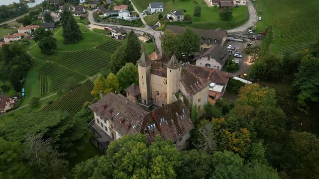 Pull back tilt up drone shot of Vaumarcus Castle in Canton of Neuchatel Switzerland