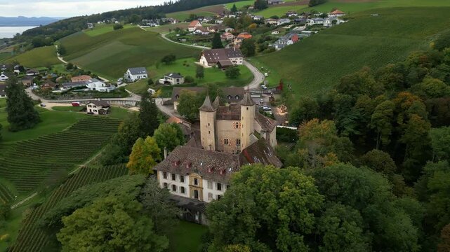 Orbit drone shot of beautiful Vaumarcus Castle in Canton of Neuchatel Switzerland