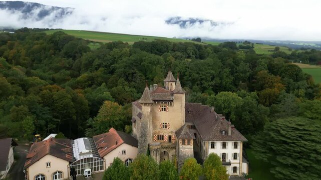 Crane up tilt down drone shot of Vaumarcus Castle in Canton of Neuchatel Switzerland