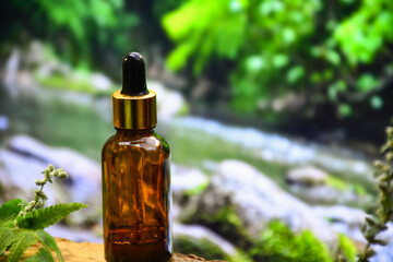 aromatherapy bottle with oil for homeopathic medicine or herbal medicine. Massage Oils. Natural cosmetics, skin care product in brown glass bottle on wood. Bottle with floral essential oil, close up 