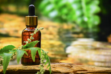 aromatherapy bottle with oil for homeopathic medicine or herbal medicine. Massage Oils. Natural cosmetics, skin care product in brown glass bottle on wood. Bottle with floral essential oil, close up 