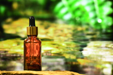 aromatherapy bottle with oil for homeopathic medicine or herbal medicine. Massage Oils. Natural cosmetics, skin care product in brown glass bottle on wood. Bottle with floral essential oil, close up 