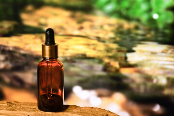 aromatherapy bottle with oil for homeopathic medicine or herbal medicine. Massage Oils. Natural cosmetics, skin care product in brown glass bottle on wood. Bottle with floral essential oil, close up 