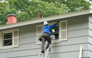 contractor working on replacing the window of the house