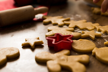 Close up of some Christmas cookies on table with red star shaped mold for cookies