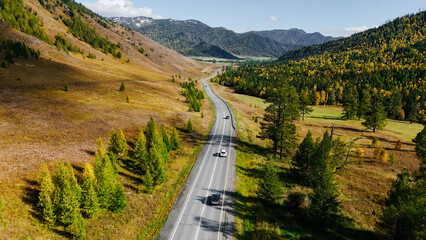 the car is driving along the Chuisky highway in Altai in autumn